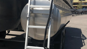 You’re looking at the front of a boat trailer with a ladder and strap over the pontoon, highlighting how pontoon trailer bunks support and secure the boat during transport